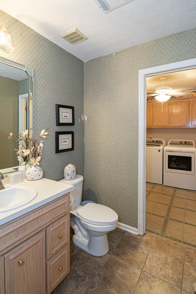 7386 Garrett Road Midland, GA 31820 - Photo 19 of 29 a spacious bathroom with a toilet a sink and a mirror