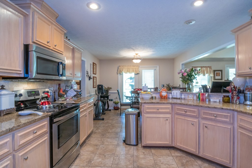 7386 Garrett Road Midland, GA 31820 - Photo 21 of 29 a kitchen with lots of appliances a sink a cabinets and a window
