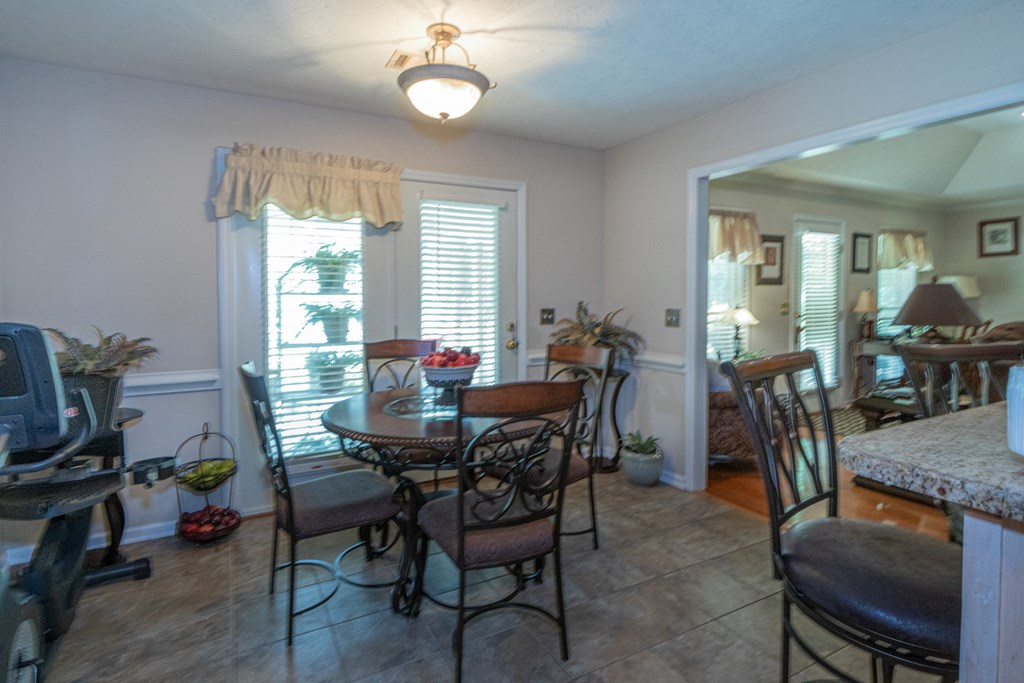 7386 Garrett Road Midland, GA 31820 - Photo 23 of 29 a view of a dining room with furniture and a window