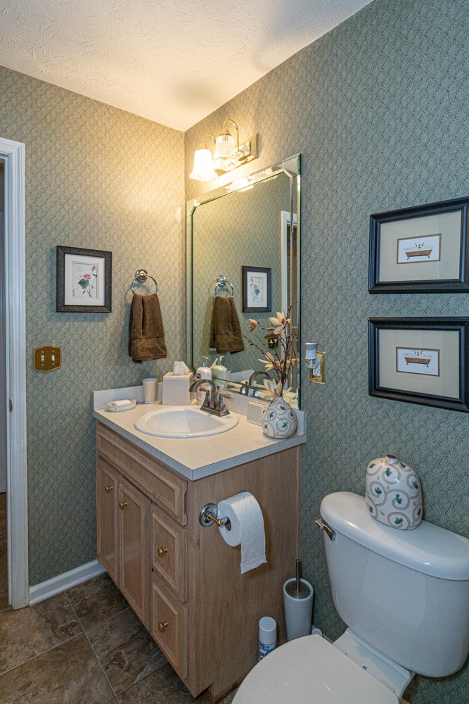 7386 Garrett Road Midland, GA 31820 - Photo 24 of 29 a bathroom with a toilet sink and mirror