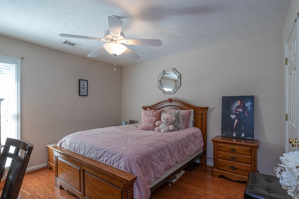 7386 Garrett Road Midland, GA 31820 - Photo 7 of 29 a bedroom with a bed and a chandelier