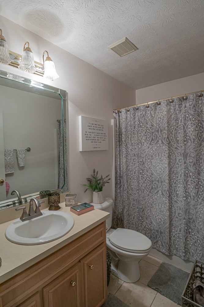 7386 Garrett Road Midland, GA 31820 - Photo 9 of 29 a bathroom with a granite countertop toilet sink and mirror
