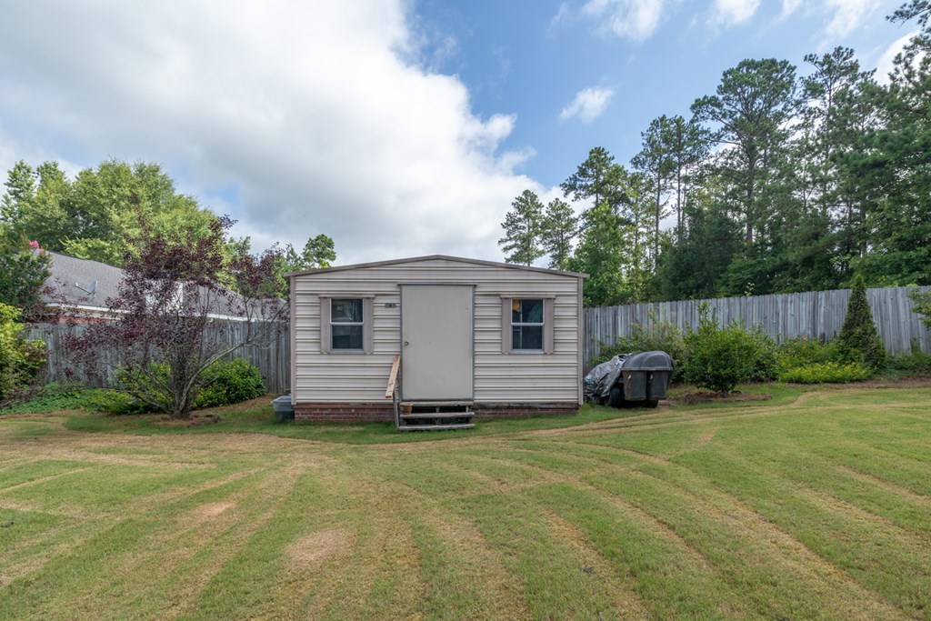 7386 Garrett Road Midland, GA 31820 - Photo 10 of 29 a view of a house with backyard and garden