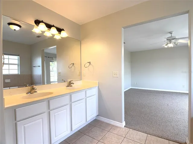 a bathroom with a double vanity sink mirror and