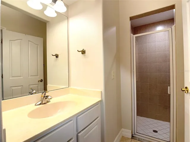 a bathroom with a granite countertop toilet a sink and a mirror