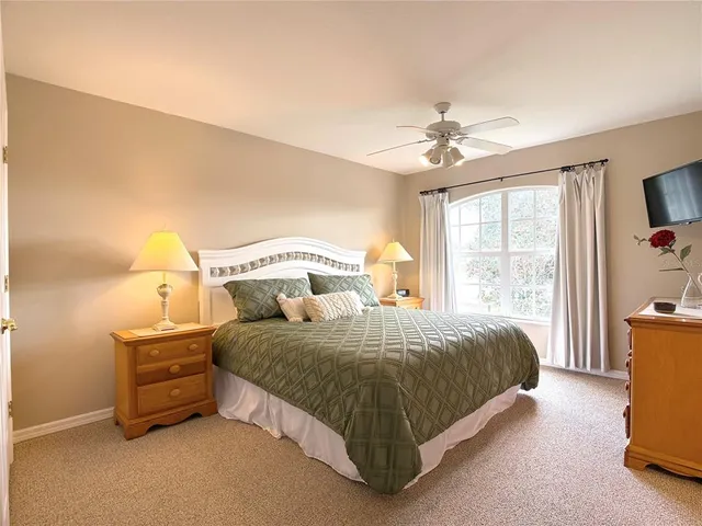 a view of a bedroom with wooden floor and cabinet