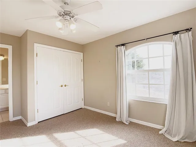 a view of a room with a ceiling fan