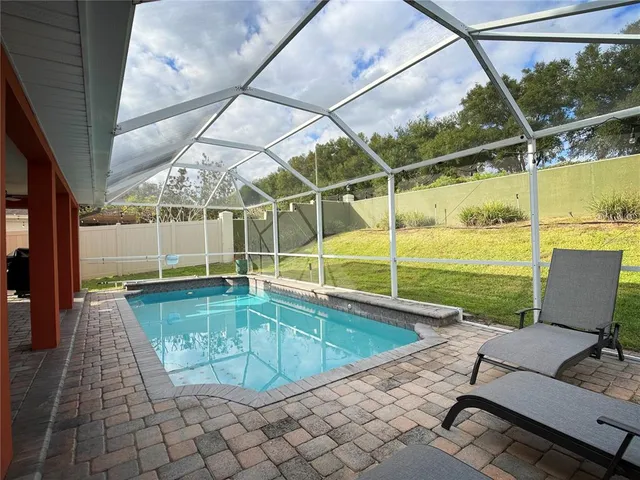 a view of swimming pool with outdoor seating