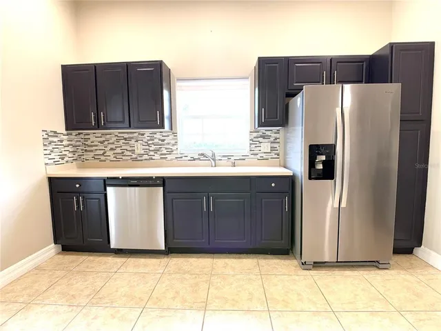 a kitchen with stainless steel appliances a refrigerator and a sink