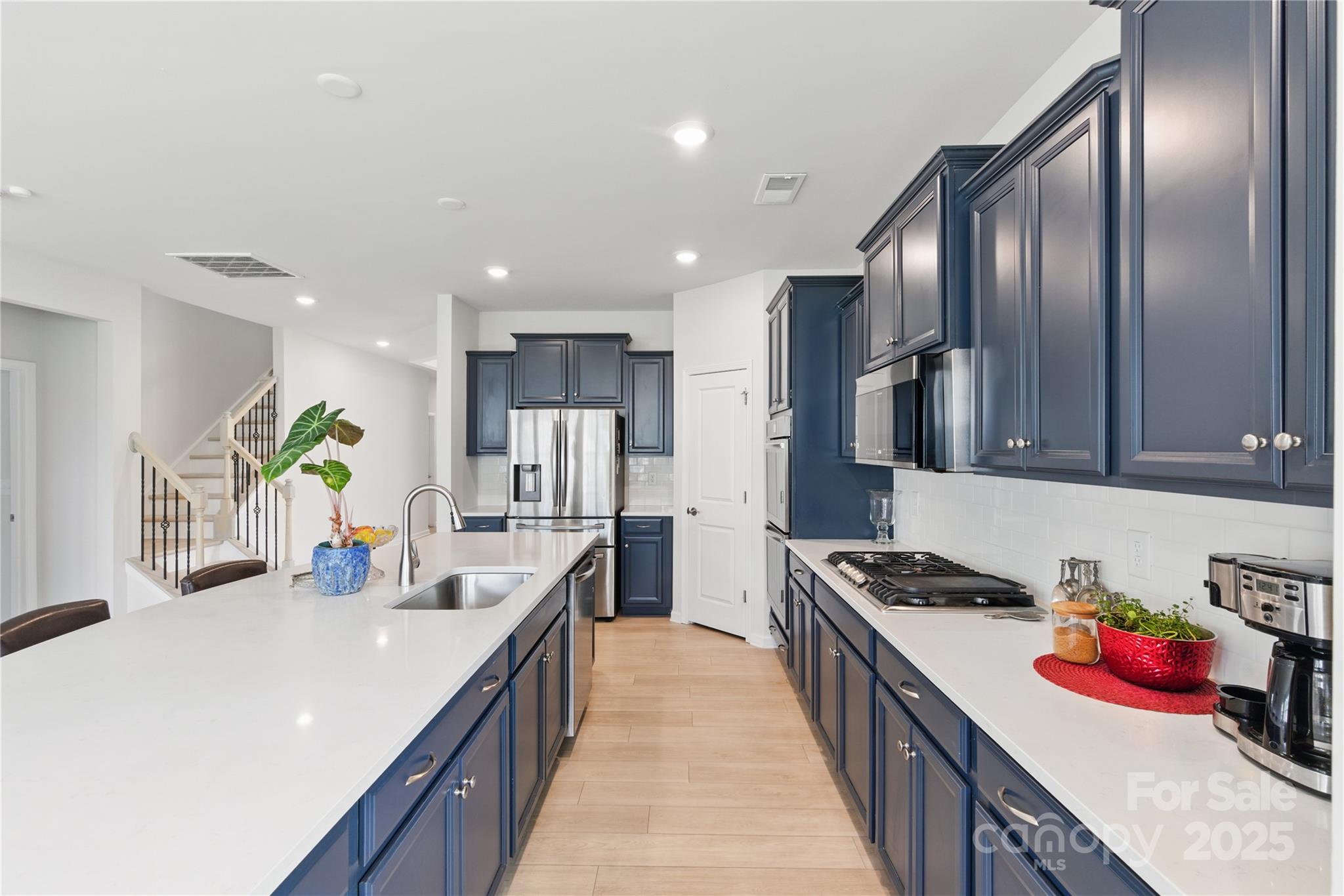 4069 Havenport Circle Tega Cay, SC 29708 - Photo 11 of 48 a kitchen with stainless steel appliances granite countertop sink stove and cabinets