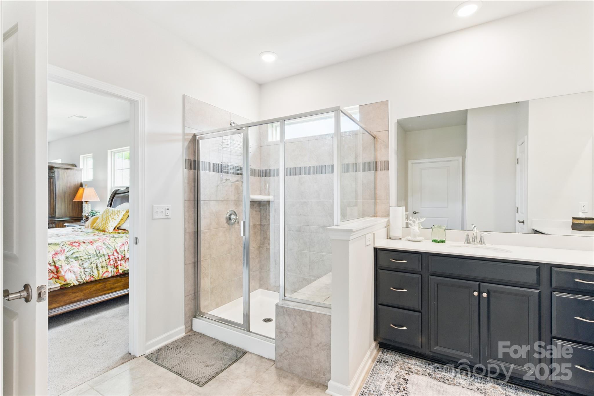 4069 Havenport Circle Tega Cay, SC 29708 - Photo 22 of 48 a bathroom with a double vanity sink and mirror with shower