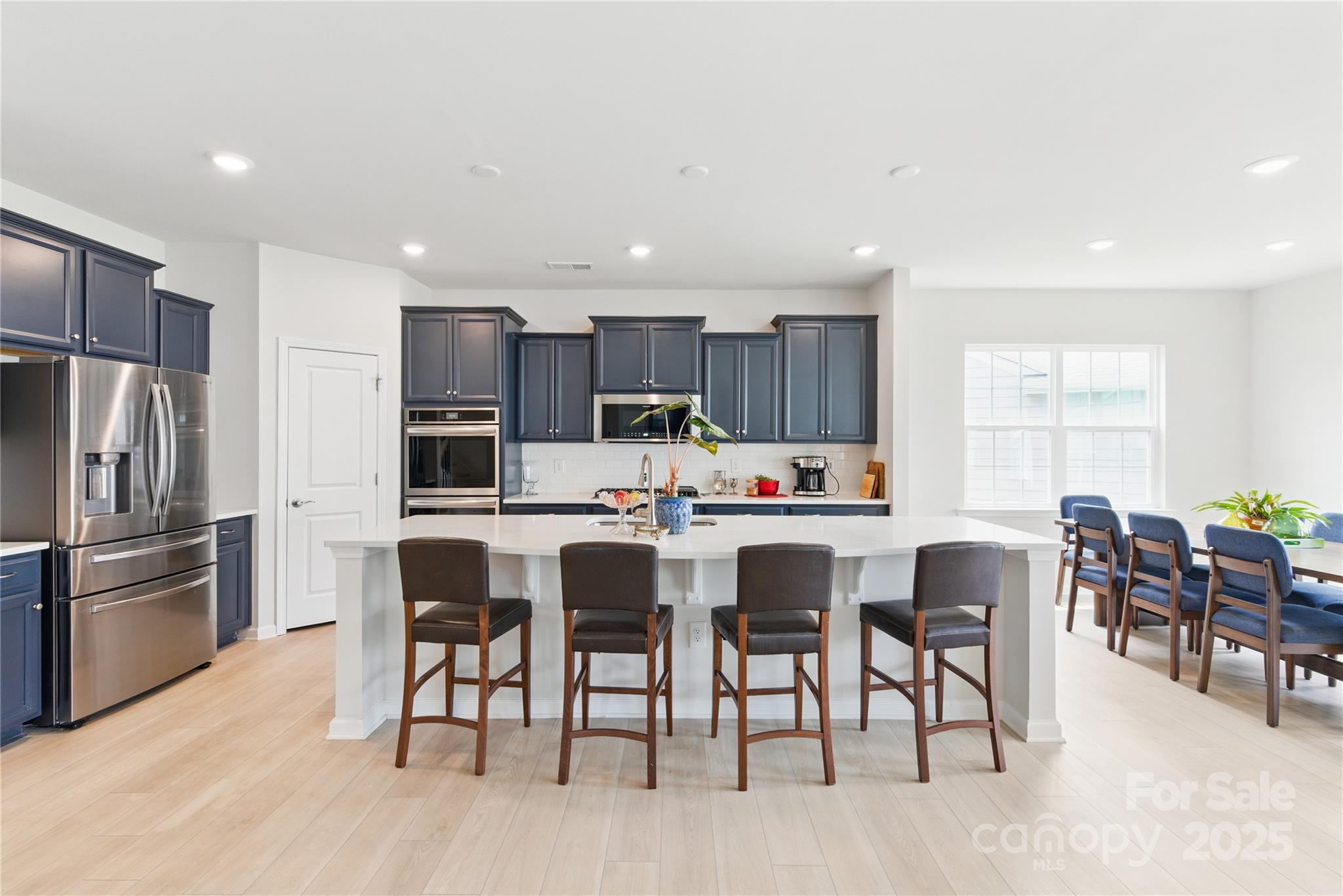 4069 Havenport Circle Tega Cay, SC 29708 - Photo 6 of 48 a kitchen with kitchen island wooden cabinets and stainless steel appliances