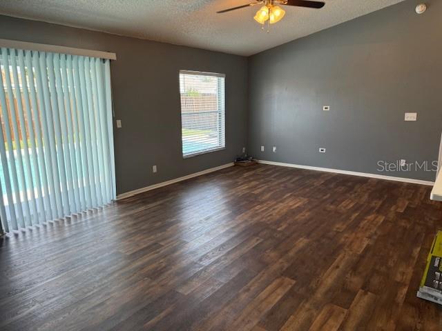 3407 Fox Ridge Street Winter Haven, FL 33884 - Photo 4 of 16 an empty room with wooden floor and windows