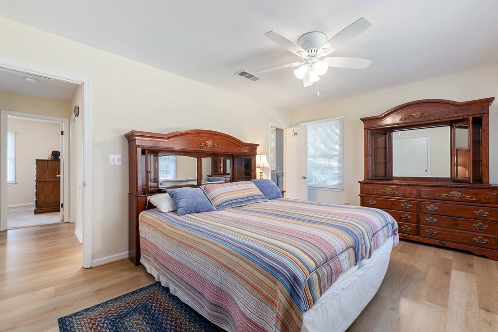 4807 Fairview Drive Columbus, GA 31907 - Photo 13 of 24 a bedroom with a large bed and a chandelier