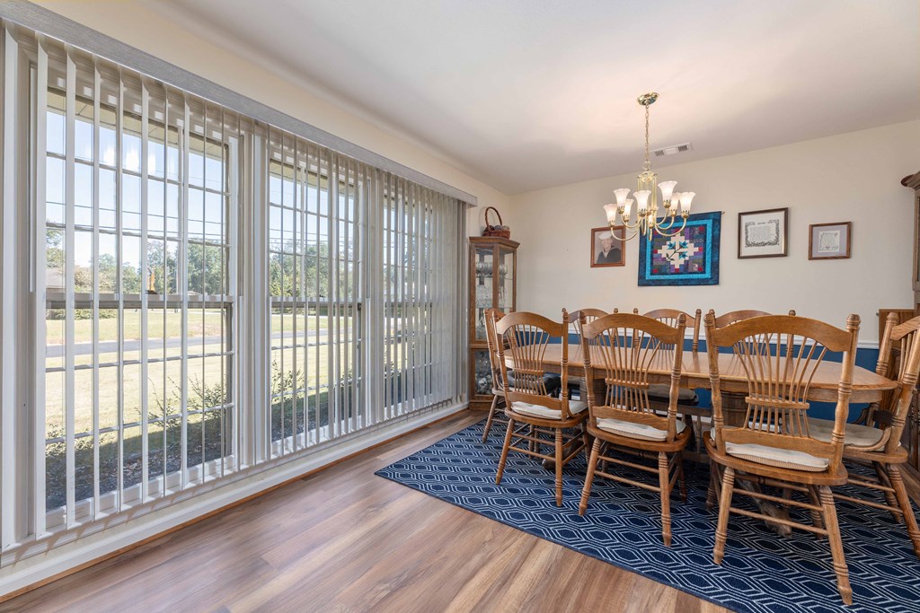 4807 Fairview Drive Columbus, GA 31907 - Photo 2 of 24 a dining room with furniture a chandelier and wooden floor