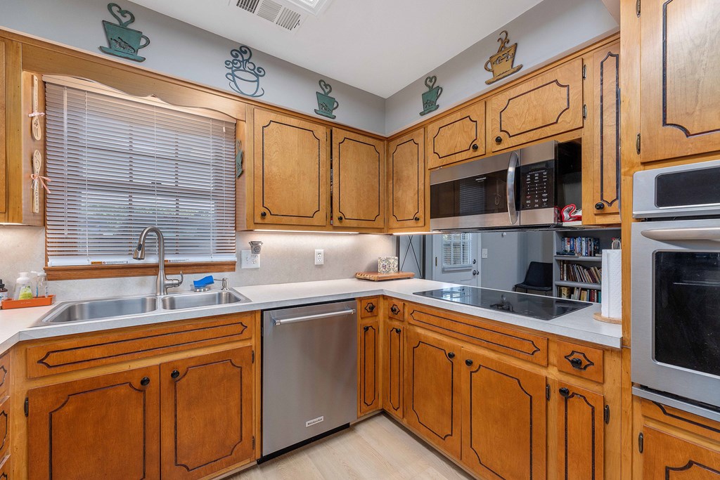 4807 Fairview Drive Columbus, GA 31907 - Photo 9 of 24 a kitchen with stainless steel appliances granite countertop a sink stove microwave and cabinets