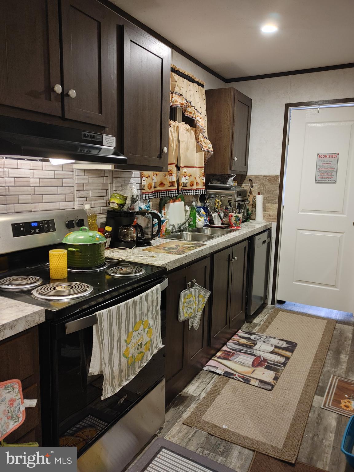 1446 Gibson Road, Unit D50 Bensalem, PA 19020 - Photo 3 of 8 a kitchen with stainless steel appliances granite countertop a stove a sink and a microwave