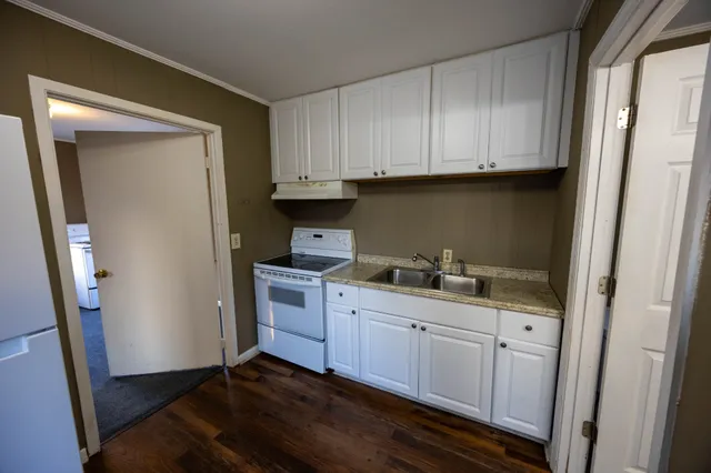 a kitchen with stainless steel appliances white cabinets and a sink