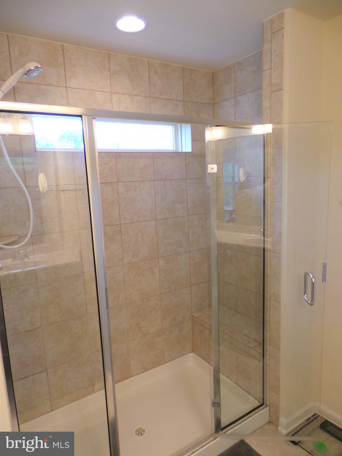 25278 Arrowroot Terrace Chantilly, VA 20152 - Photo 22 of 30 a bathroom with a glass shower door