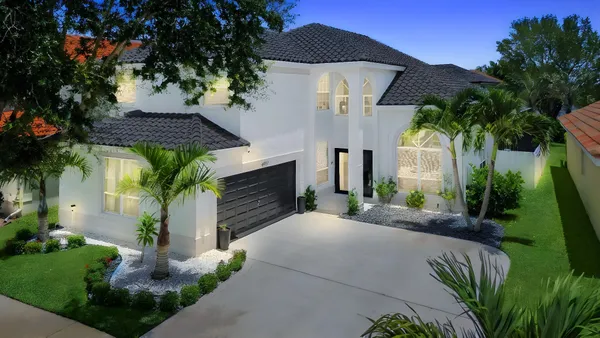a front view of a house with a yard