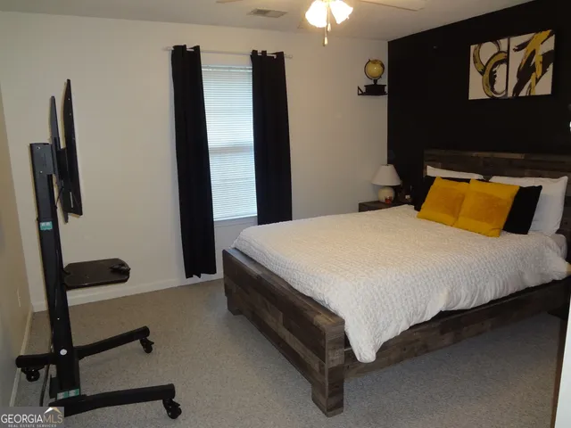 a bedroom with a bed and a window