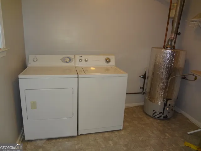 a bathroom with a granite countertop sink a mirror and a bathtub