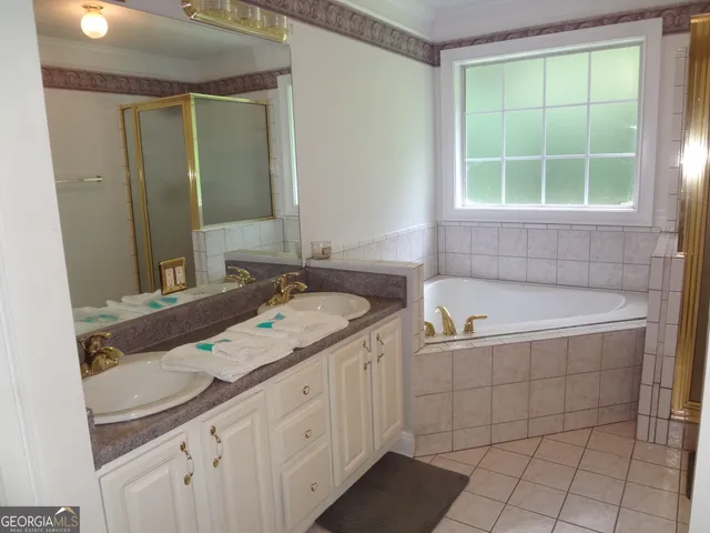 a bathroom with a granite countertop bathtub shower and toilet