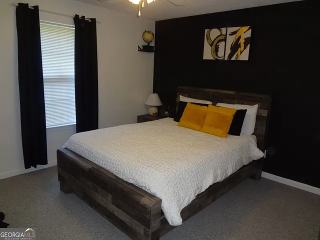 a bed sitting in a bedroom next to a wooden cabinet