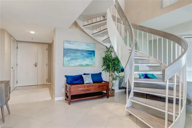 a living room with furniture and a stairs