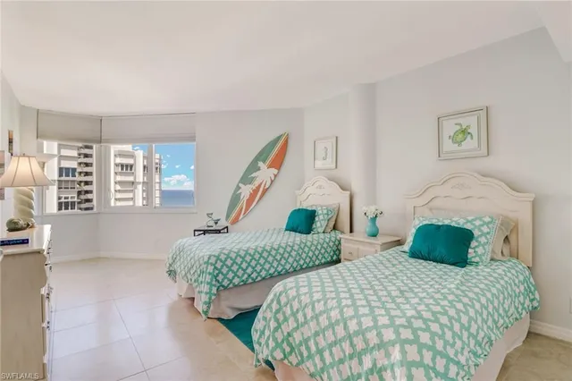 a bedroom with two beds and a window