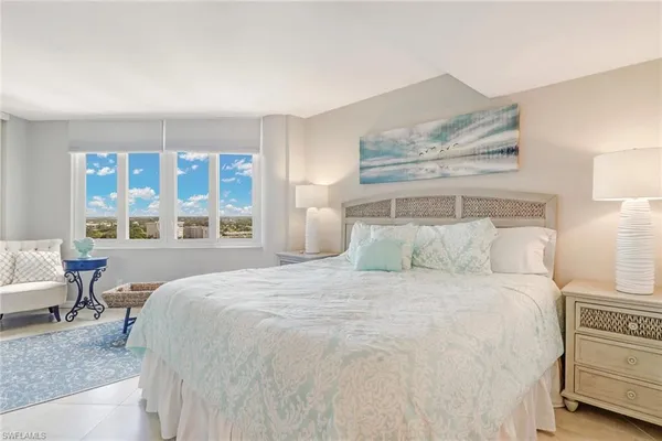 a bedroom with a large bed and a window