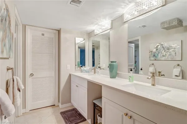 a bathroom with a double vanity sink mirror and