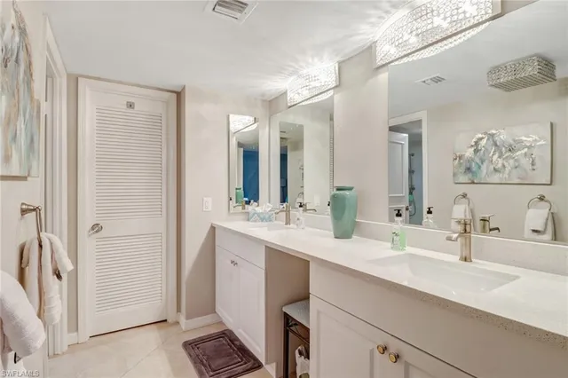 a bathroom with a double vanity sink mirror and
