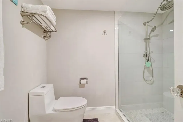 a bathroom with a shower a toilet and a shower