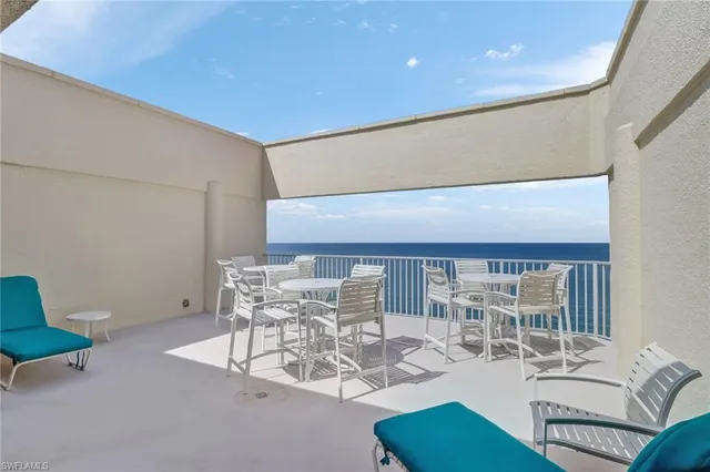 a work room with furniture and a large window