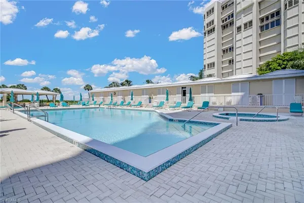 a view of a swimming pool with a lounge chairs