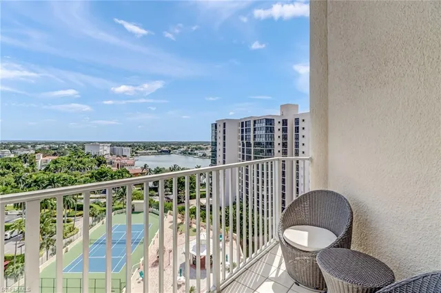 a view of a balcony with chair and wooden floor