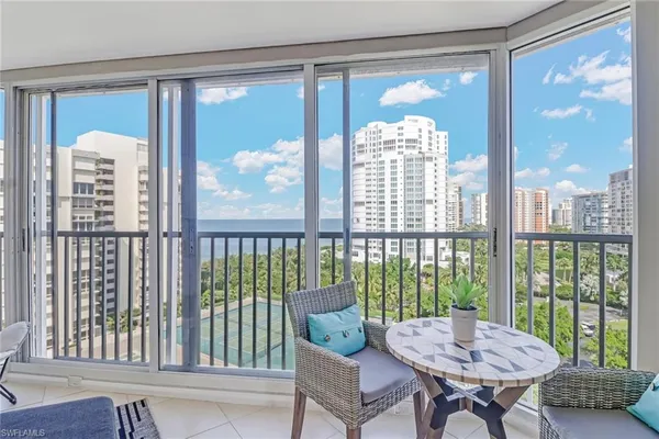 a living room with a large window and a table