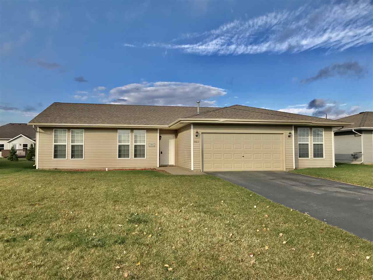 15612 Stonecrest Road South Beloit, IL 61080 - Photo 1 of 14 a view of a yard in front of a house with a large tree