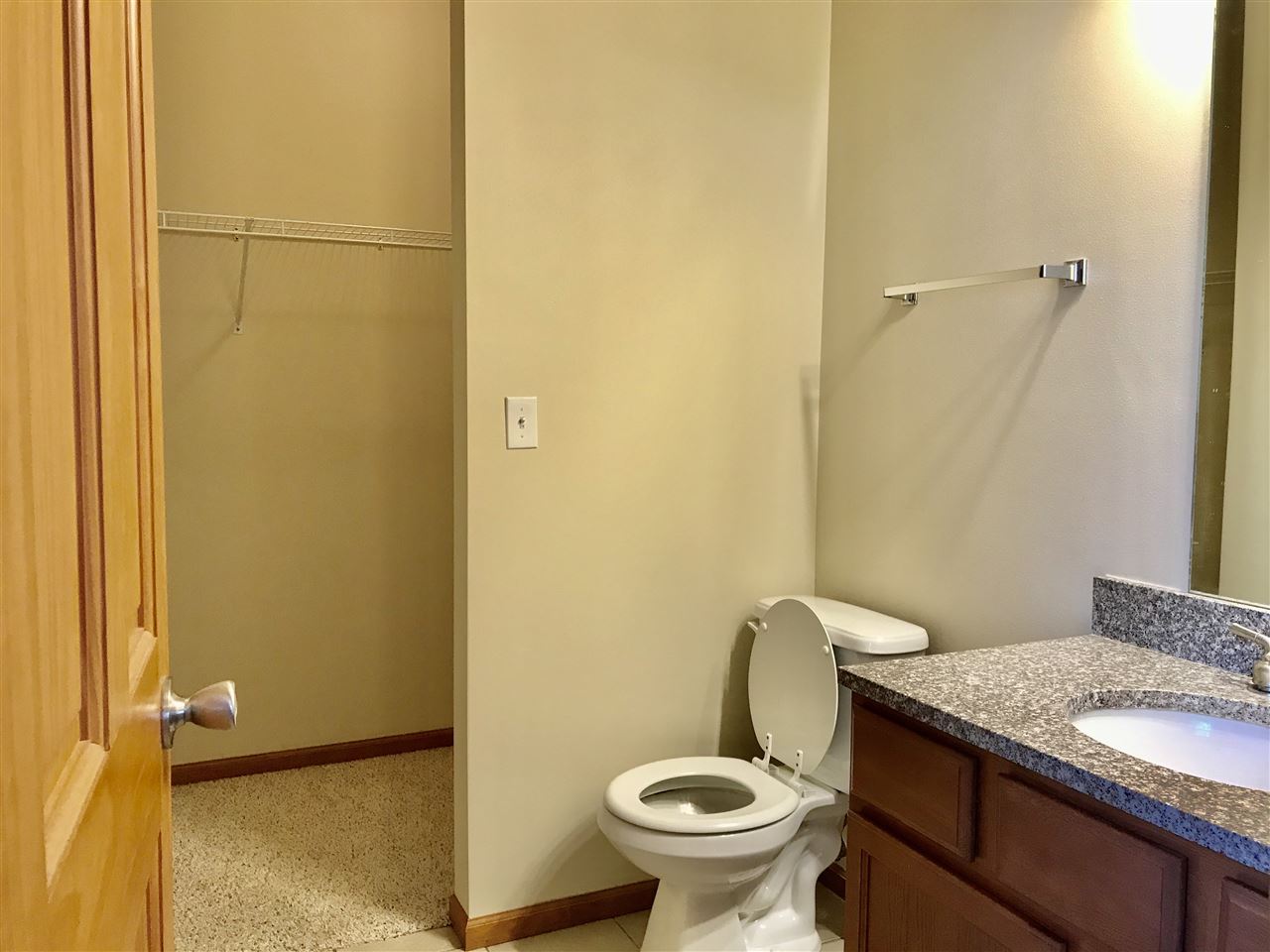 15612 Stonecrest Road South Beloit, IL 61080 - Photo 9 of 14 a bathroom with a granite countertop toilet and a sink
