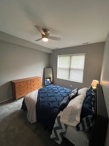 a bedroom with a bed and window