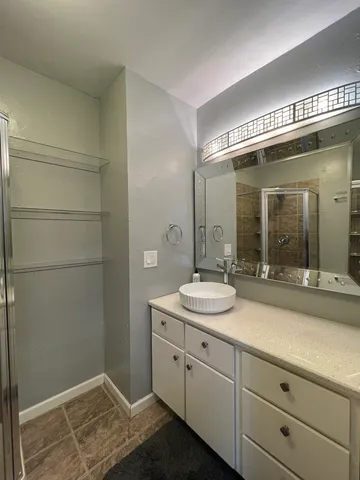 a living room with furniture and a baby crib