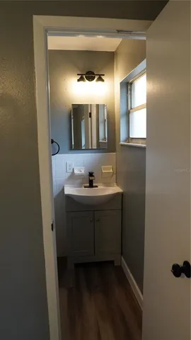 a bathroom with a sink vanity and mirror