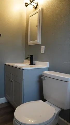 a white toilet sitting next to a bathroom sink