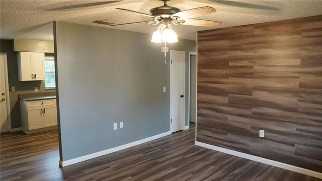 a view of a hallway with closet and wooden floor