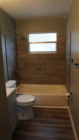 a bathroom with a toilet and a bathtub