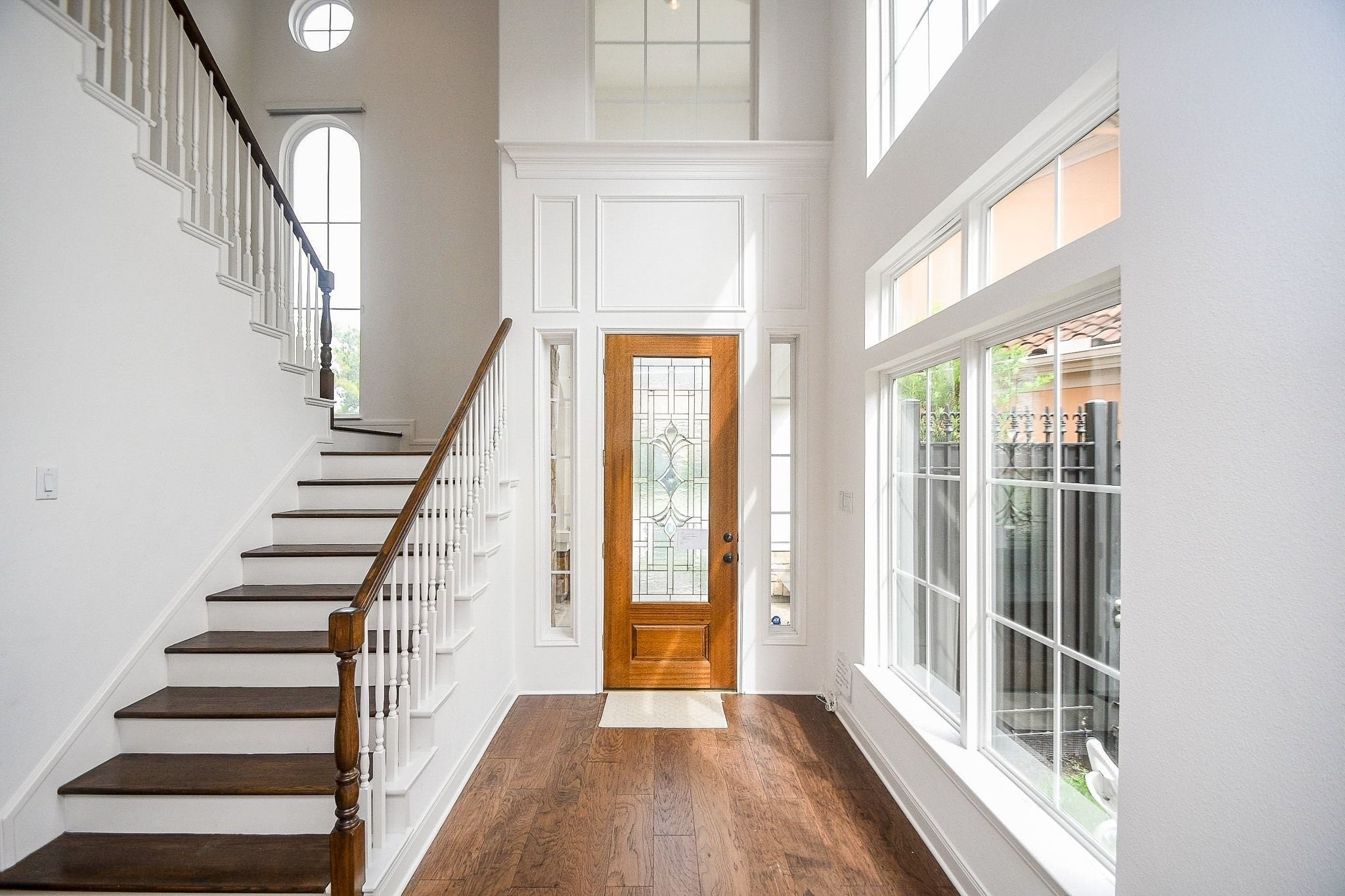 2826 Tudor Manor Houston, TX 77082 - Photo 2 of 37 Impressive entrance featuring 20-foot ceilings and an abundance of natural light streaming through expansive windows.