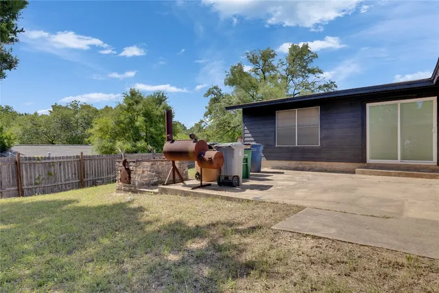 a backyard of a house with table and chairs