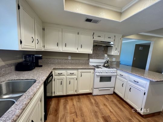 401 South Lincoln Street Ridgecrest, CA 93555 - Photo 6 of 27 a kitchen with stainless steel appliances granite countertop a sink stove and cabinets