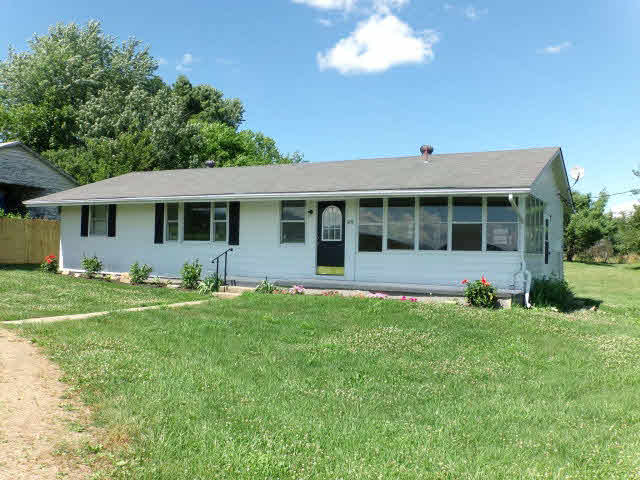 1659 Orchard Road Mount Jackson, VA 22842 - Photo 1 of 13 a front view of a house with a yard table and chairs